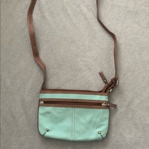 A Crossbody bag that is teal and brown